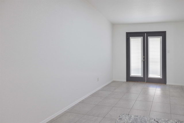 376 N 22nd Dr, San Luis, AZ 85336 - empty room with french doors, baseboards, and light tile patterned floors