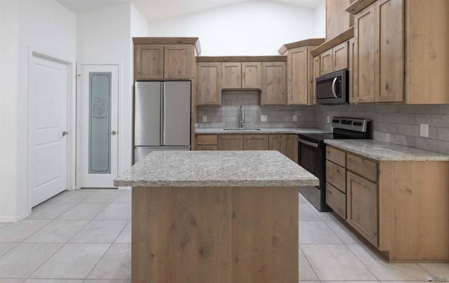376 N 22nd Dr, San Luis, AZ 85336 - kitchen with a sink, tasteful backsplash, stainless steel appliances, and light tile patterned flooring