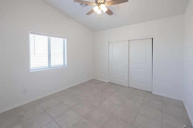 376 N 22nd Dr, San Luis, AZ 85336 - unfurnished bedroom featuring visible vents, a closet, baseboards, ceiling fan, and vaulted ceiling