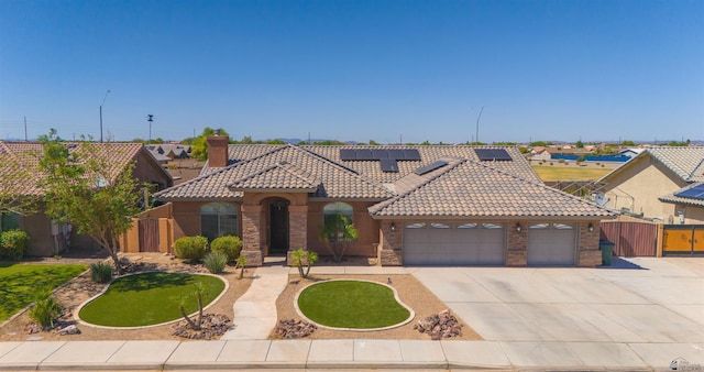 6194 E 46th Ln, Yuma, AZ 85365 - mediterranean / spanish house featuring a tile roof, fence, an attached garage, and concrete driveway