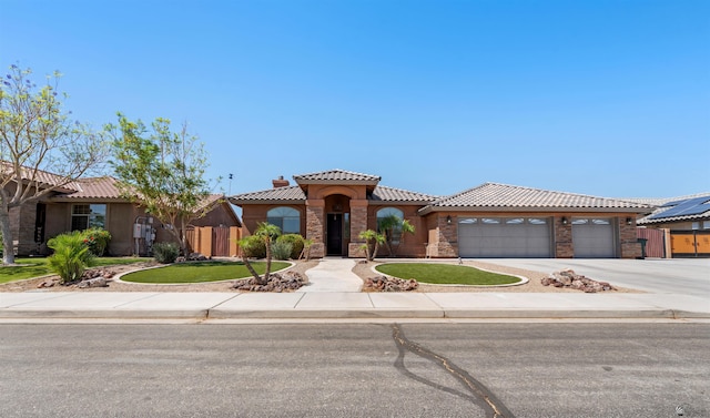 6194 E 46th Ln, Yuma, AZ 85365 - mediterranean / spanish-style home with a tile roof, driveway, an attached garage, and stucco siding