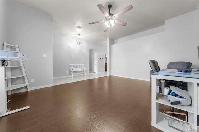 6194 E 46th Ln, Yuma, AZ 85365 - living room with arched walkways, a ceiling fan, wood finished floors, and baseboards