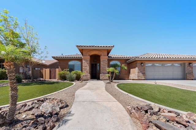6194 E 46th Ln, Yuma, AZ 85365 - mediterranean / spanish house with stone siding, a tiled roof, a front lawn, a garage, and concrete driveway