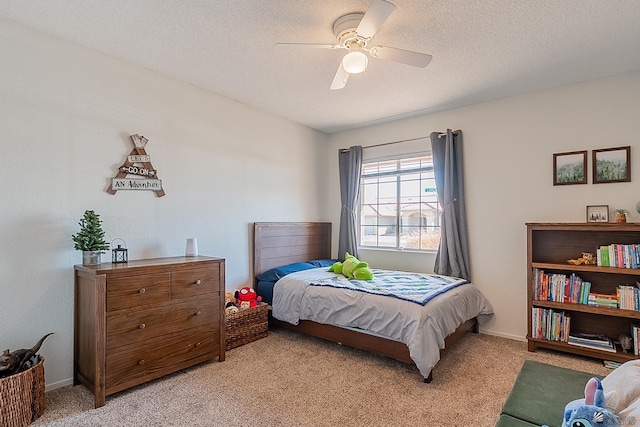 bedroom with light colored carpet, a ceiling fan, a textured ceiling, and baseboards