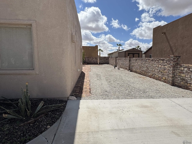 13815 E 54th St, Yuma, AZ 85367 - view of property exterior with fence, stucco siding, and a patio area