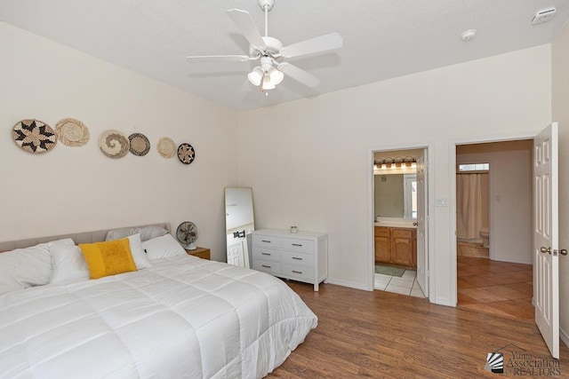 10758 E 39th St, Yuma, AZ 85365 - bedroom with wood finished floors, ensuite bathroom, a ceiling fan, and baseboards