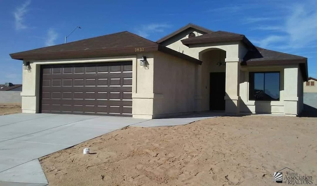 ranch-style home with a garage and driveway