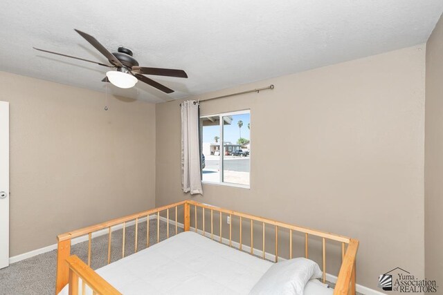 carpeted bedroom with baseboards and ceiling fan