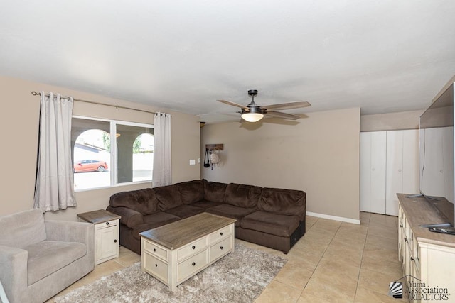 living area with ceiling fan and light tile patterned floors