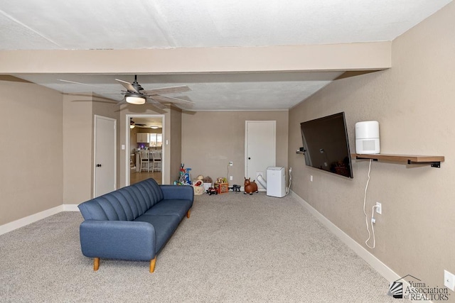 sitting room with baseboards, carpet, and a ceiling fan