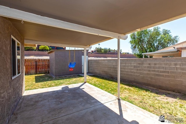 view of patio with a fenced backyard and an outbuilding