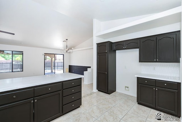 2967 S 47th Ave, Yuma, AZ 85364 - kitchen with a chandelier, vaulted ceiling, light countertops, and light tile patterned floors