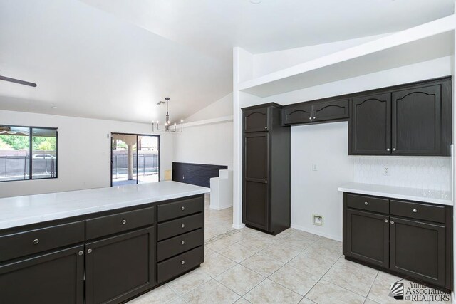2967 S 47th Ave, Yuma, AZ 85364 - kitchen with a chandelier, vaulted ceiling, light countertops, and light tile patterned floors