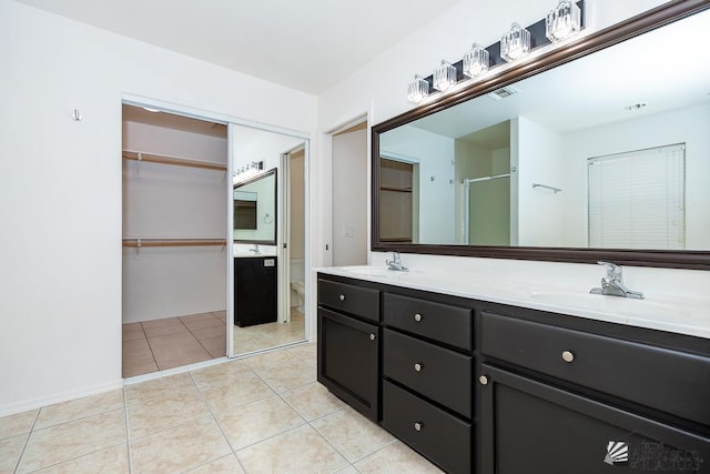 2967 S 47th Ave, Yuma, AZ 85364 - bathroom with double vanity, a shower stall, tile patterned flooring, and a spacious closet