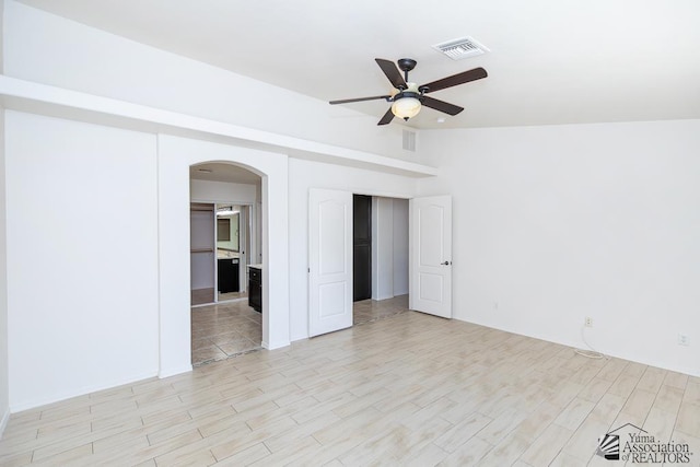 2967 S 47th Ave, Yuma, AZ 85364 - spare room with ceiling fan, arched walkways, and light wood-style floors