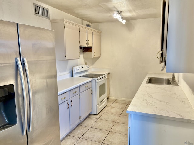 1805 S Dora Ave, Yuma, AZ 85364 - kitchen featuring stainless steel refrigerator with ice dispenser, white electric stove, light countertops, and light tile patterned flooring