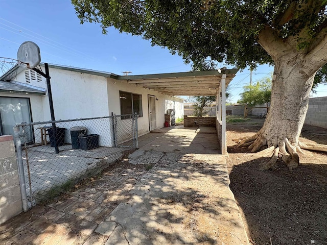 1805 S Dora Ave, Yuma, AZ 85364 - view of side of home with a patio area and stucco siding