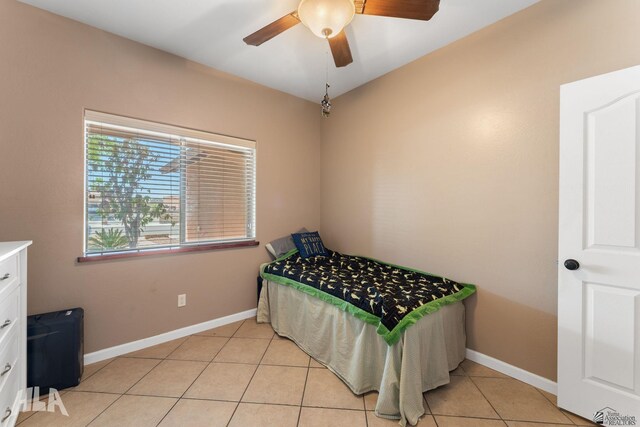 bedroom featuring baseboards, ceiling fan, and light tile patterned floors