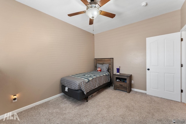 bedroom featuring baseboards, ceiling fan, and carpet