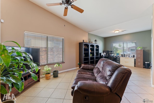 living area with visible vents, a ceiling fan, lofted ceiling, and tile patterned flooring