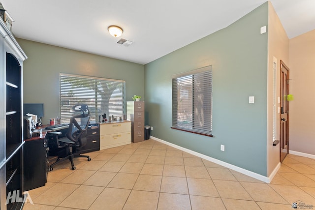office featuring baseboards, light tile patterned flooring, and visible vents