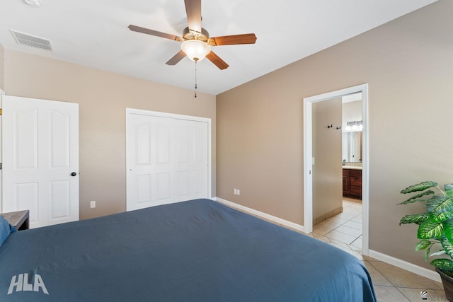 bedroom featuring ceiling fan, visible vents, light tile patterned floors, baseboards, and a closet