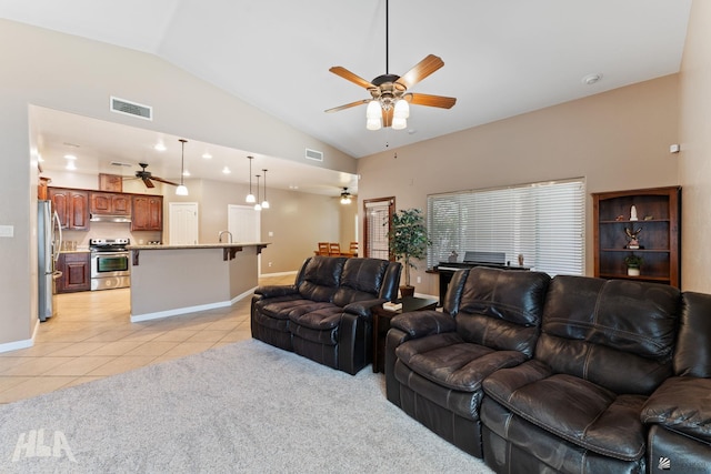 living area featuring vaulted ceiling, light tile patterned floors, a ceiling fan, and visible vents