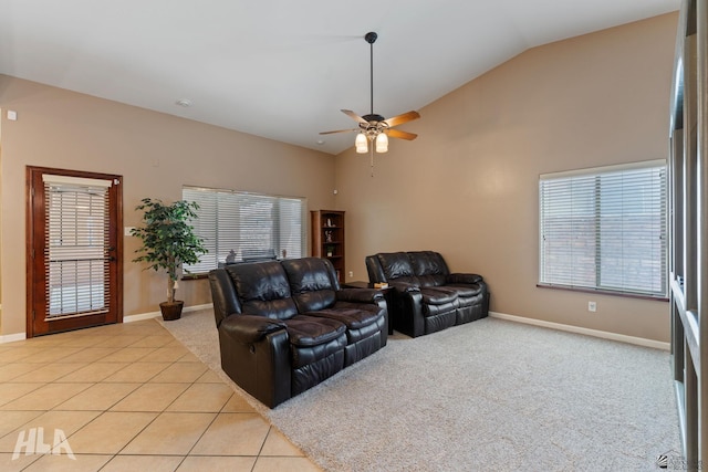 living room with a ceiling fan, baseboards, a wealth of natural light, and lofted ceiling