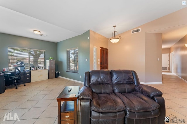living area with visible vents, baseboards, and light tile patterned floors
