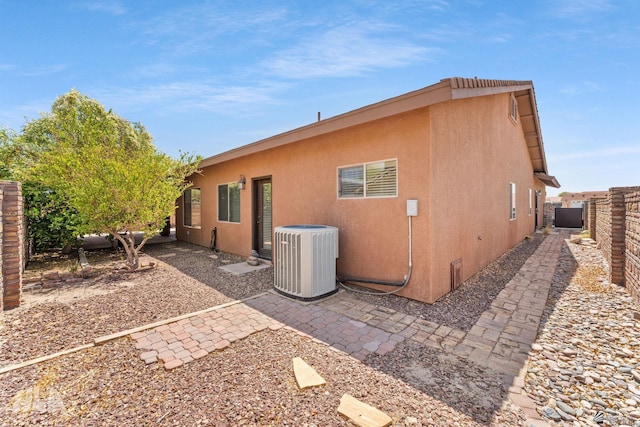 back of property with a patio, a fenced backyard, stucco siding, and cooling unit