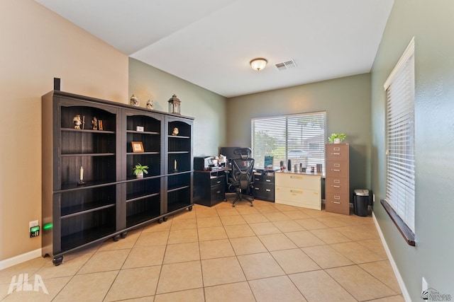 home office with light tile patterned flooring, baseboards, and visible vents