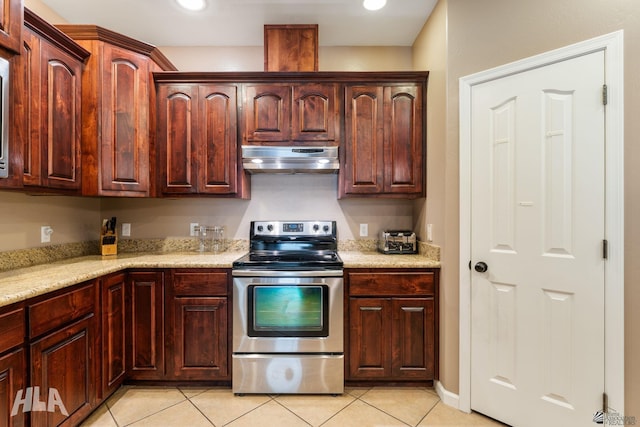 kitchen featuring electric range, light stone countertops, recessed lighting, light tile patterned floors, and under cabinet range hood