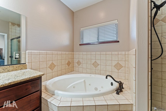 bathroom with vanity, a whirlpool tub, and a stall shower