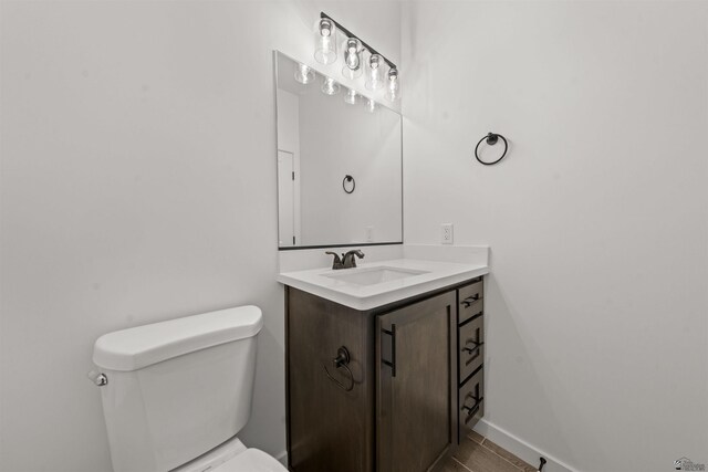 10778 E 45th Ln, Yuma, AZ 85367 - half bathroom featuring toilet, vanity, and baseboards