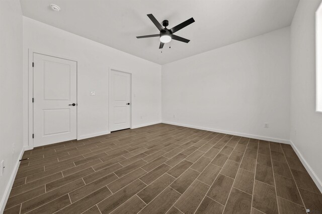 10778 E 45th Ln, Yuma, AZ 85367 - unfurnished room with dark wood-type flooring, a ceiling fan, a smoke detector, and baseboards