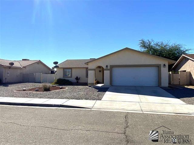11281 E 27th St, Yuma, AZ 85367 - ranch-style house featuring concrete driveway, an attached garage, and stucco siding