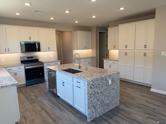 kitchen with a sink, stainless steel appliances, white cabinetry, dark wood-type flooring, and visible vents