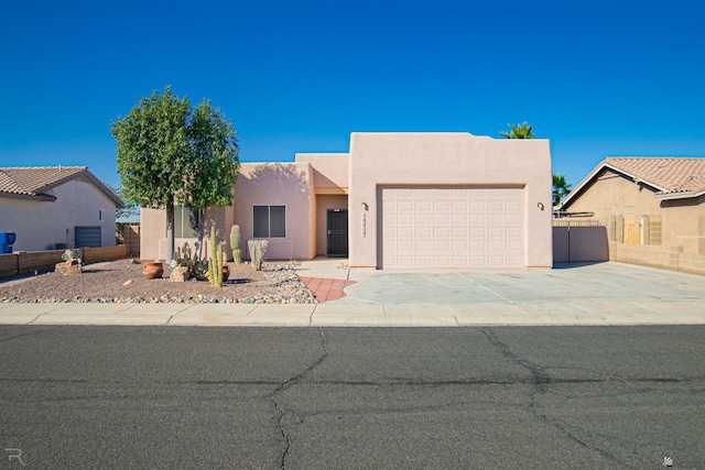 pueblo-style house with a garage