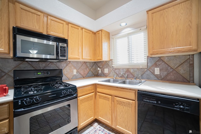 kitchen featuring appliances with stainless steel finishes, sink, light brown cabinets, and backsplash