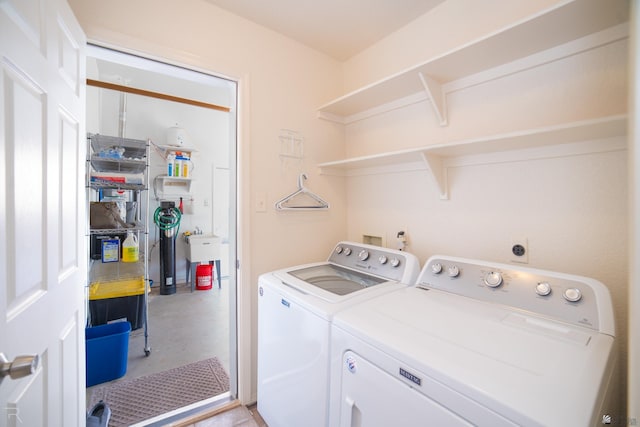 clothes washing area with separate washer and dryer