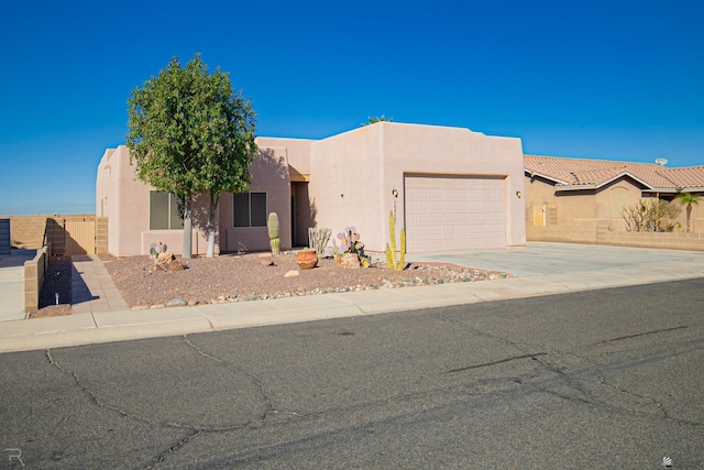 pueblo-style home featuring a garage