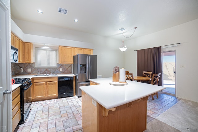 kitchen featuring a breakfast bar area, black appliances, a center island, pendant lighting, and backsplash