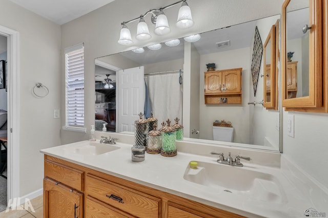 ensuite bathroom featuring visible vents, a sink, toilet, and ensuite bathroom