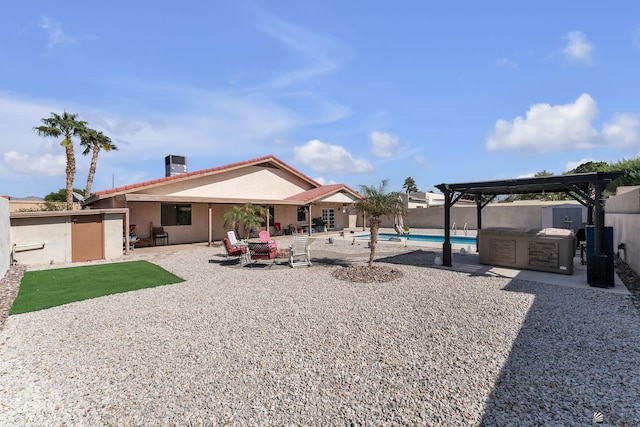 back of house featuring area for grilling, stucco siding, a fenced in pool, a pergola, and a patio area