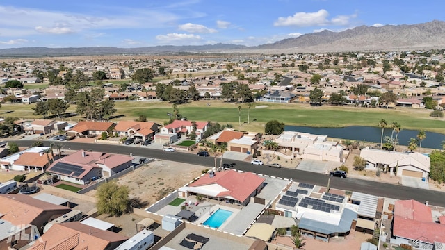 aerial view with a residential view, golf course view, and a water and mountain view