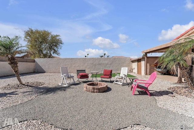 view of yard featuring an outdoor fire pit, a fenced backyard, and a patio