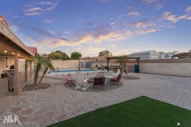 yard at dusk with a patio area, a fenced backyard, a fenced in pool, and a pergola