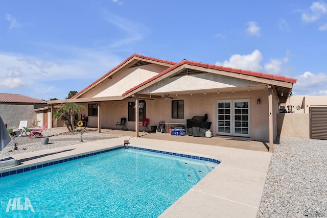 back of house featuring a fenced in pool, a patio, a ceiling fan, and stucco siding