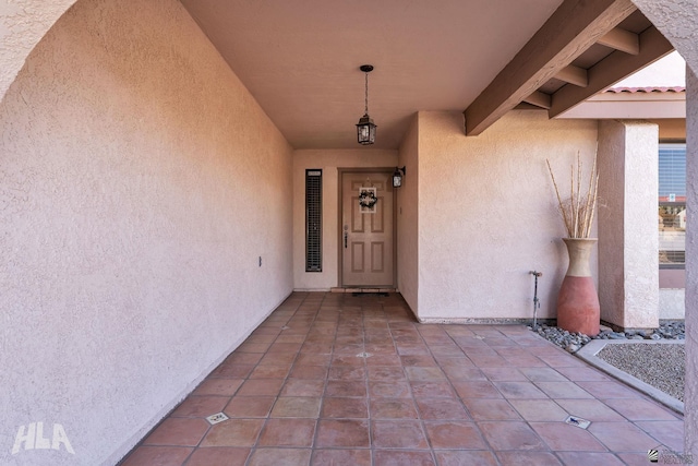 property entrance featuring stucco siding