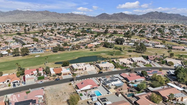 drone / aerial view with a residential view, view of golf course, and a mountain view